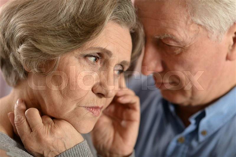 Portrait of a sad senior couple at home, stock photo