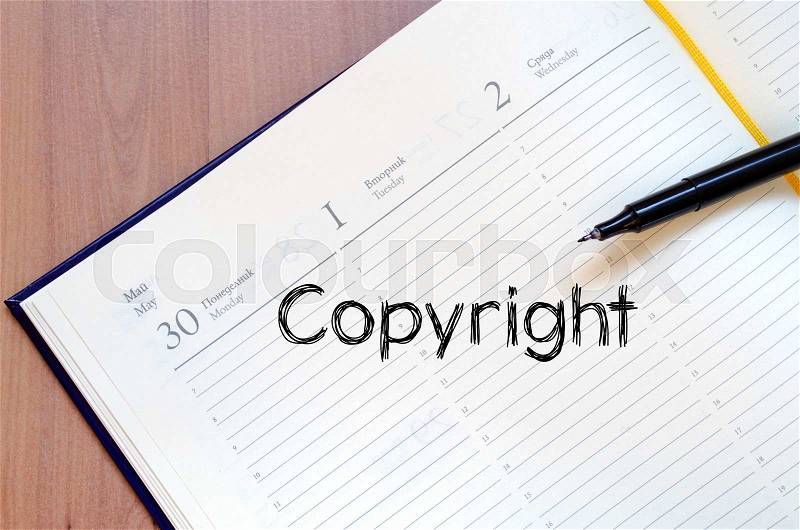 Copyright text concept write on notebook with pen, stock photo