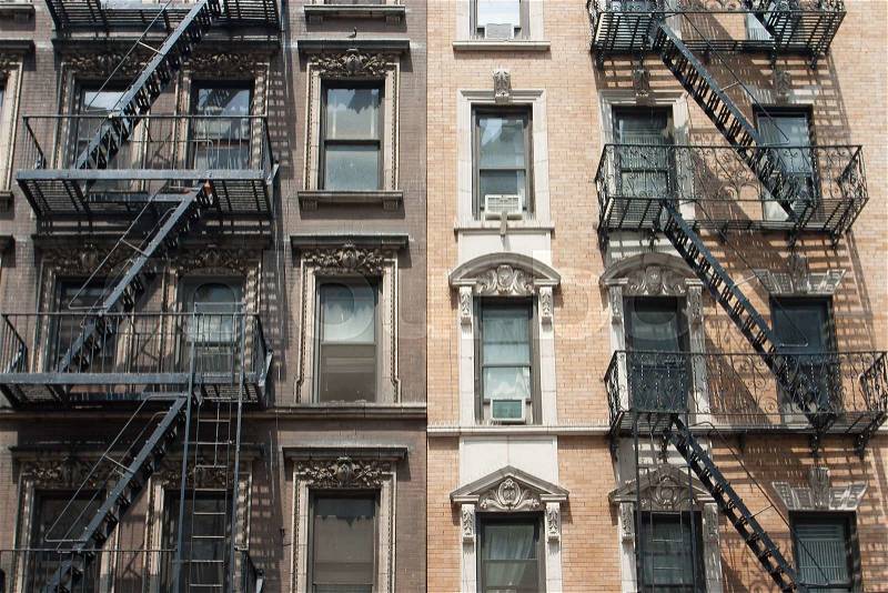 The typical old houses with fire stairs in New York in USA, stock photo