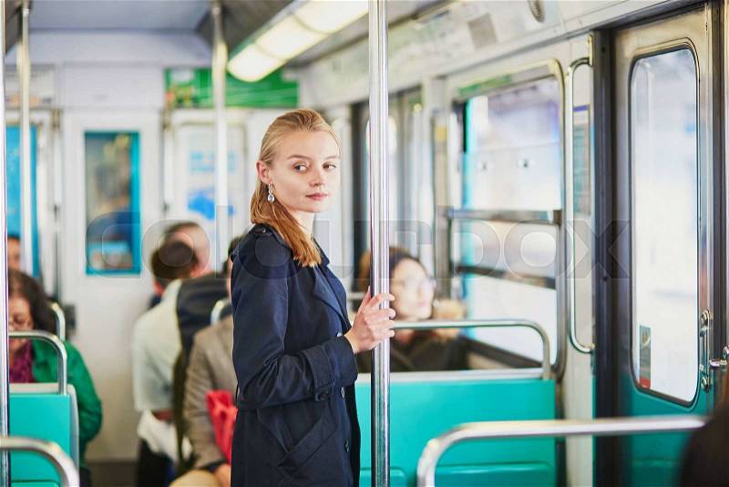 Beautiful young woman travelling in a train of Parisian underground, stock photo