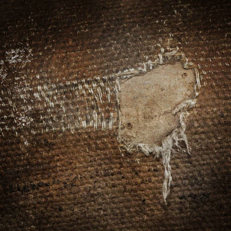 Detail (damage) of an old canvas suitcase, close-up, vintage look, stock photo