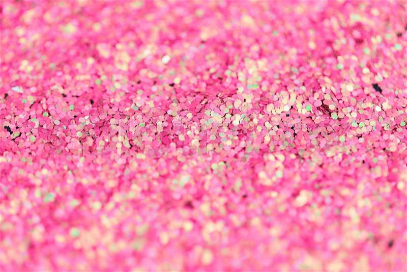 Holidays, decoration and texture concept - pink glitter or sequins background, stock photo