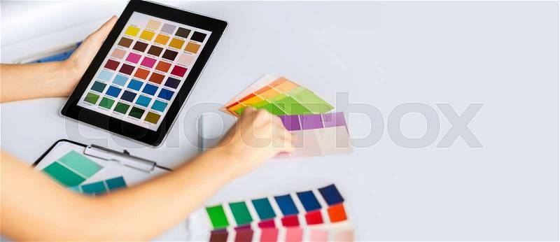 Interior design, renovation and technology concept - woman working with color samples for selection, stock photo
