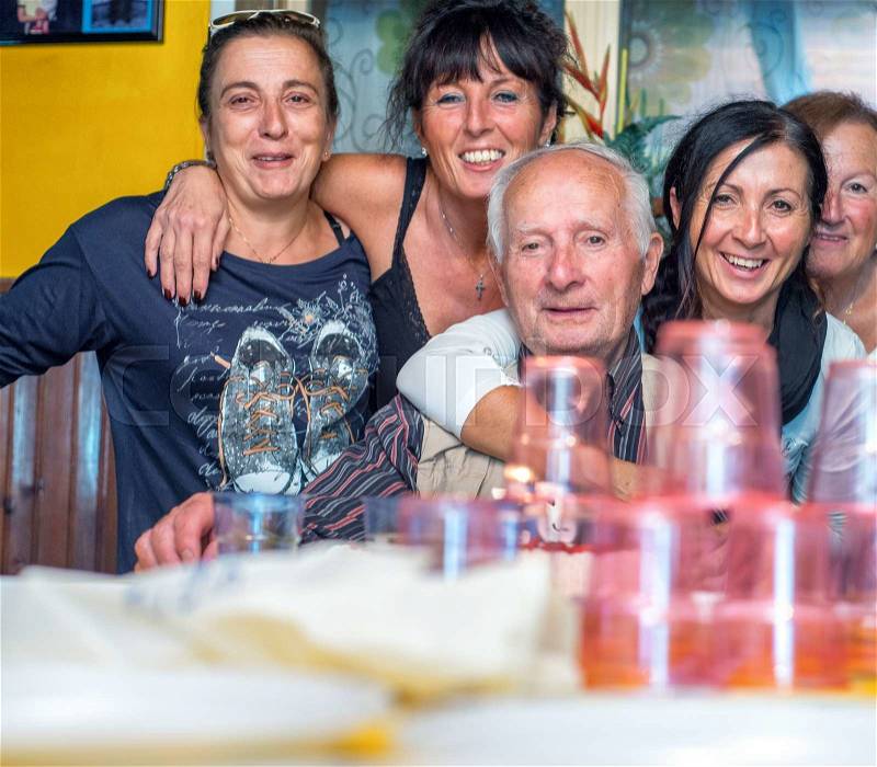 Multi generation family celebrating at the kitchen table, stock photo