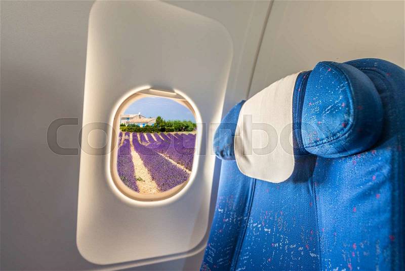 Airplane interior flying over Provence landscape with Lavender fields, stock photo