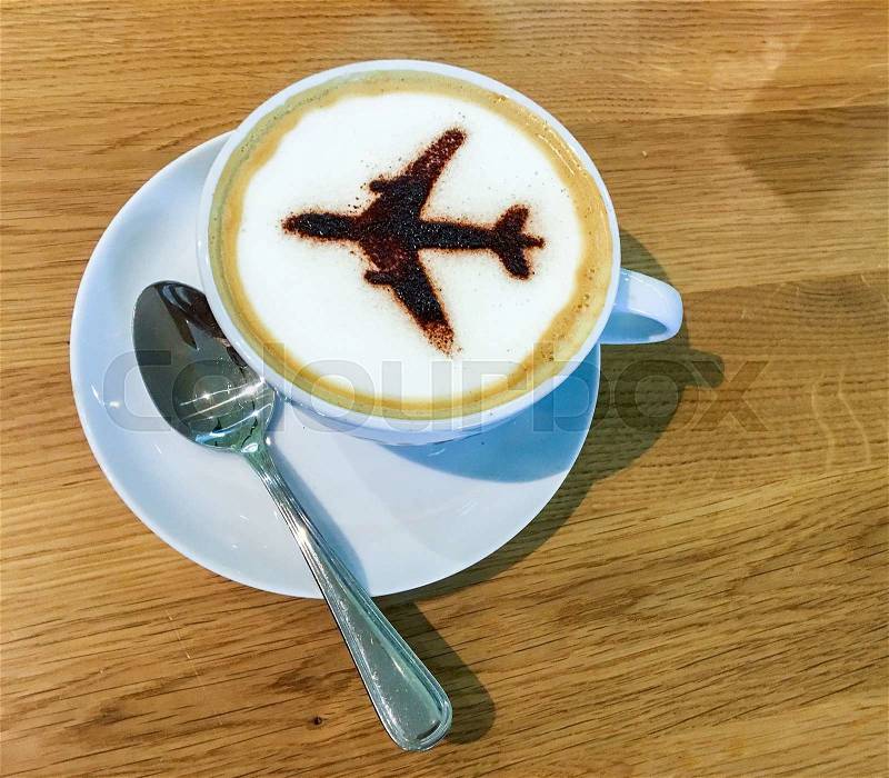 Airport coffee cup. Hot espresso on table, view from above. Airplane shape on top, stock photo