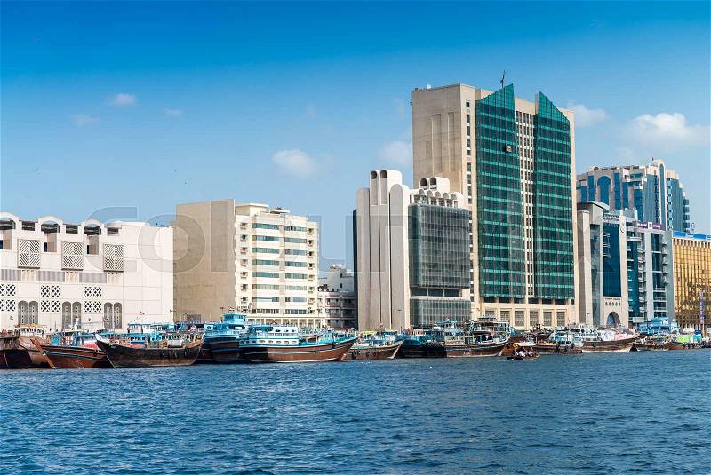 DUBAI - OCTOBER 7, 2015: Dubai creek with buildings and boats. Dubai attracys more than 10 million people worldwide annually, stock photo