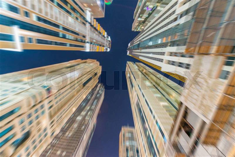 Blurred view of Dubai buildings at dusk, stock photo