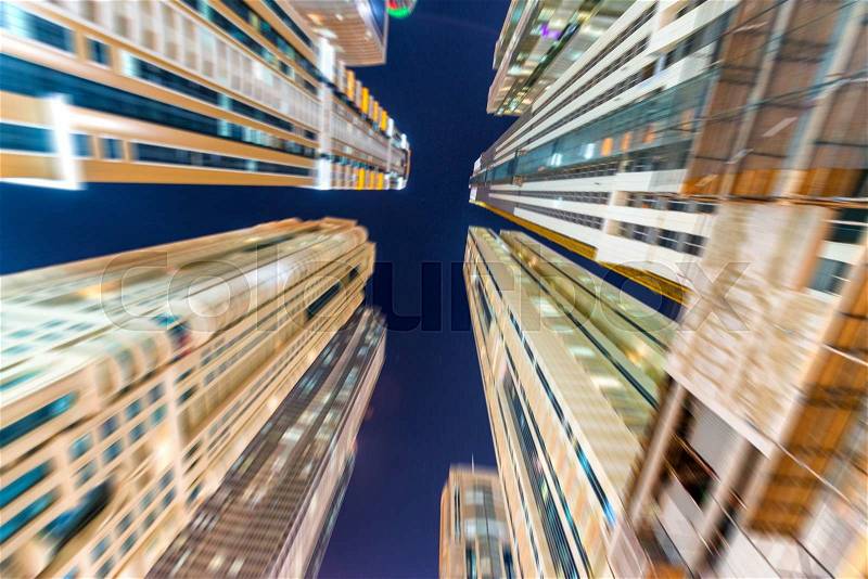 Blurred view of Dubai buildings at dusk, stock photo
