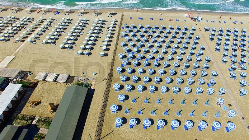 Beach umbrellas and chairs on the beach. Aerial bird eye view, stock photo