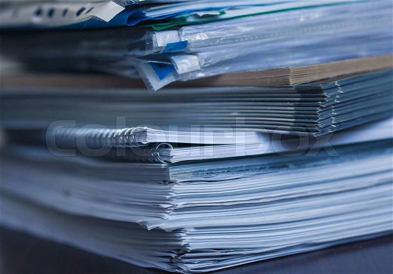 Accounting and taxes. Large pile of magazine and books closeup, stock photo
