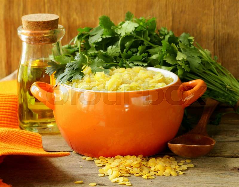 Side dish of yellow lentils with herbs and spices, stock photo