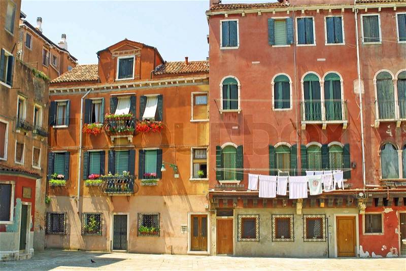 Small plaza with colourful buildings in Venice, Italy, stock photo