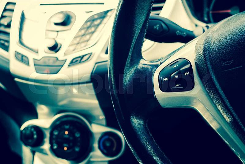Modern car interior close up to power steering with cross-processed color, stock photo