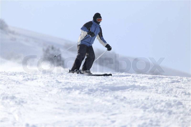 People skiing in the snow in the winter, stock photo