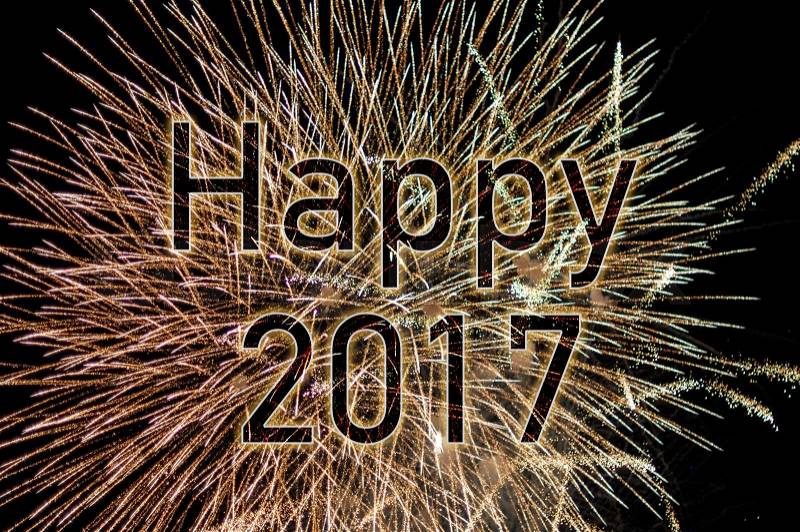 Happy New Year 2017 with colorful sparklers. The words Happy 2017 are integrated into the fireworks with black background, stock photo