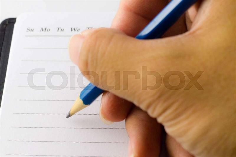 Close up of male hand signing on white paper, stock photo