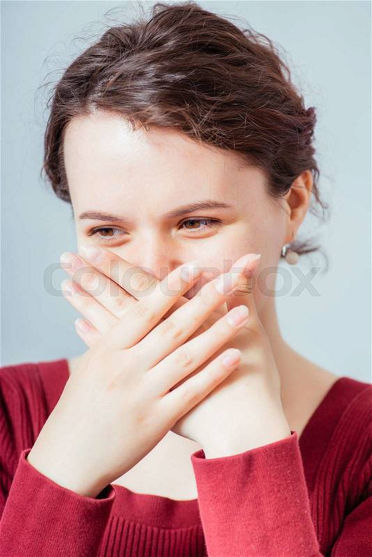 Happy woman laughing covering her mouth with a hands, stock photo
