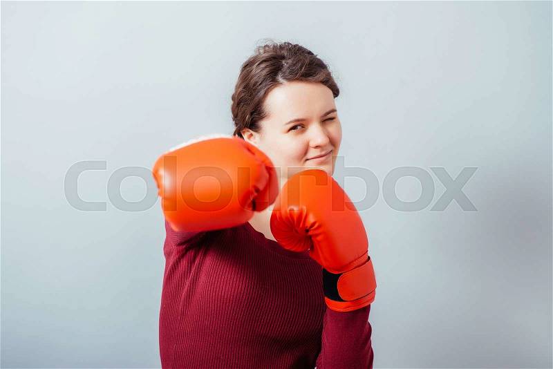 Woman with boxing gloves ready to fight, stock photo