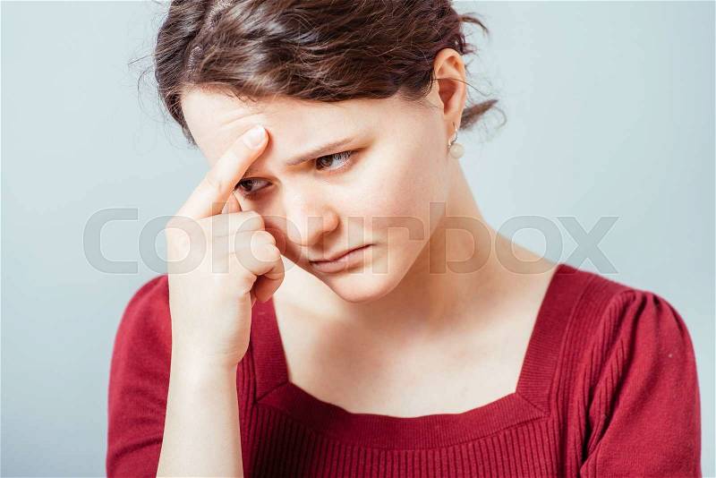 Woman thinking, trying hard to remember something, stock photo