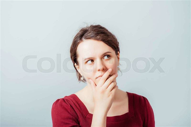 Woman thinking, trying hard to remember something looking confused, stock photo