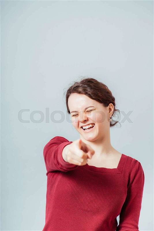 Portrait of woman pointing to someone, stock photo