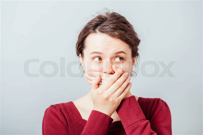 Young woman covering the face with her hands, stock photo