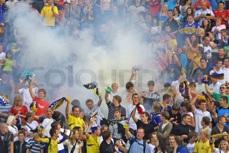 KYIV, UKRAINE - SEPTEMBER 05, 2009: Ukraine National Football team supporters burn the fires and react after scored against Andorra during 2010 FIFA World Cup qualifiers match in Kyiv on September 5, 2009, stock photo