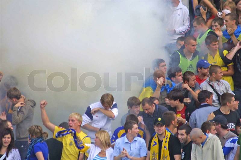 KYIV, UKRAINE - SEPTEMBER 05, 2009: Ukraine National Football team supporters burn the fires and react after scored against Andorra during 2010 FIFA World Cup qualifiers match in Kyiv on September 5, 2009, stock photo