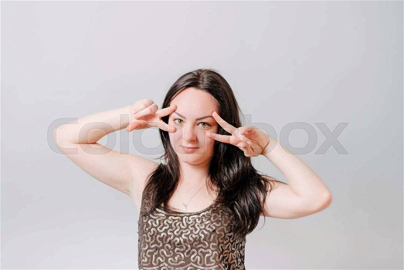 Happy smiling beautiful young woman showing two fingers or victory gesture, stock photo