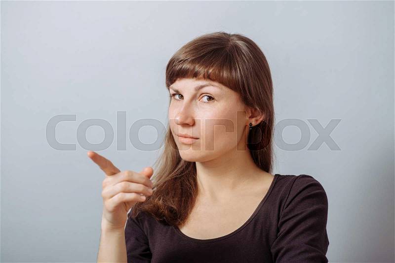 Picture of attractive businesswoman pointing her finger, stock photo