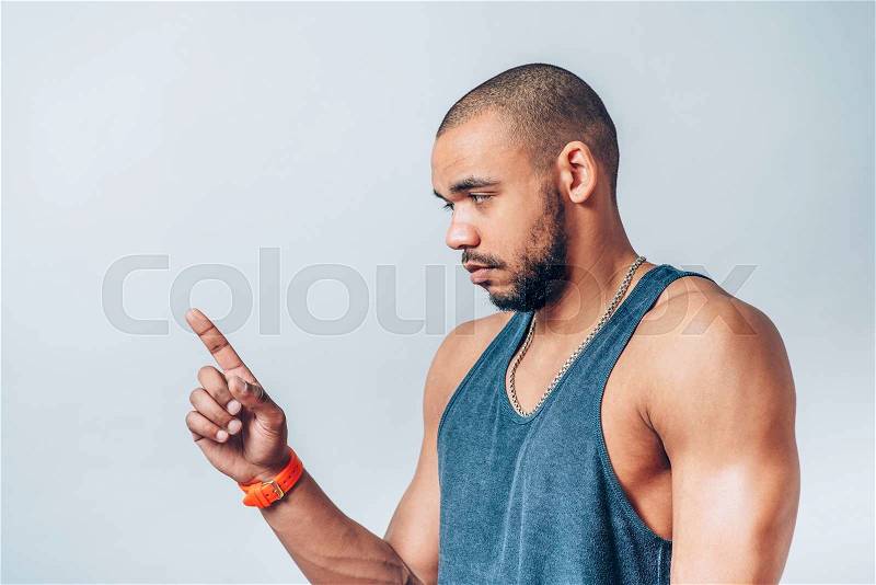 Young cool black man pointing , stock photo