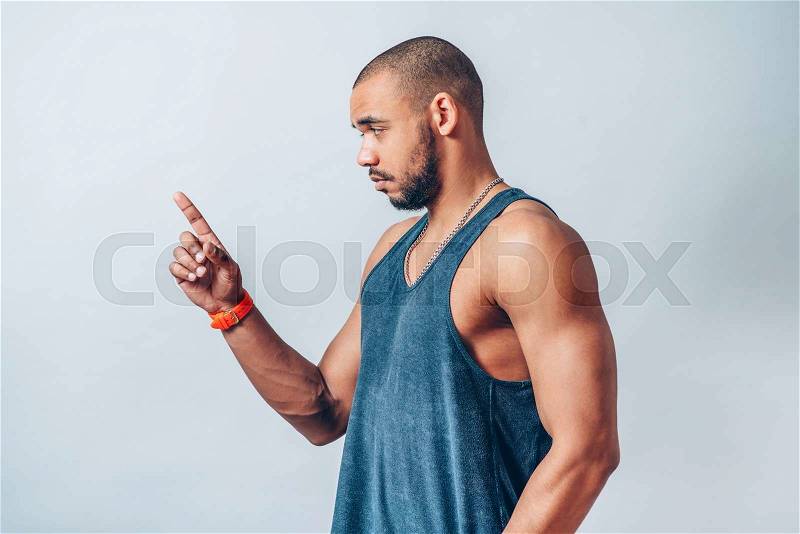 Young cool black man pointing , stock photo