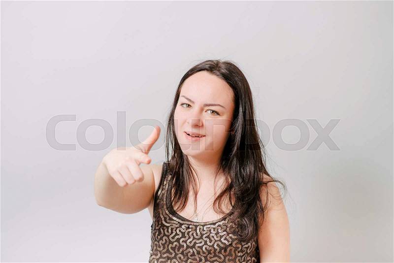 Girl points finger and taunts, stock photo