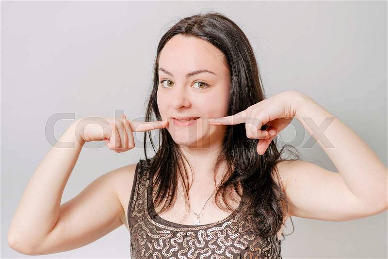 Woman showing her perfect straight white teeth, stock photo