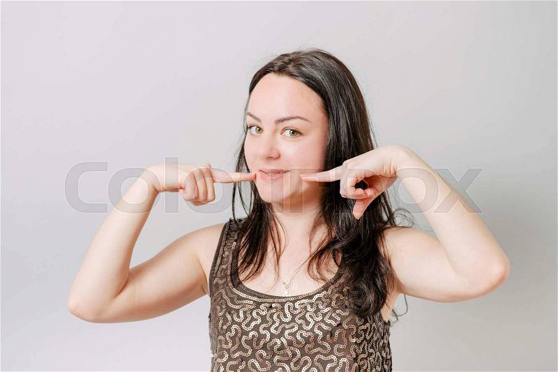 Woman showing her perfect straight white teeth, stock photo