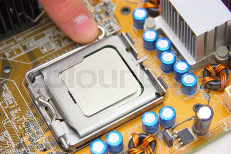 Processor on the yellow computer motherboard, stock photo