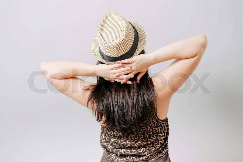 Girl with his hands behind his head, a hat, stock photo