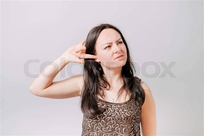 Do not want to hear anything. Young woman closing ears with hands, isolated on white, stock photo
