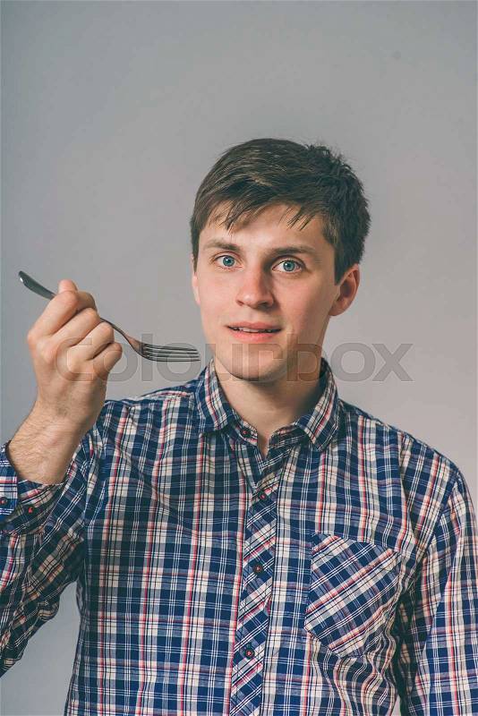 Man eat with a fork, stock photo