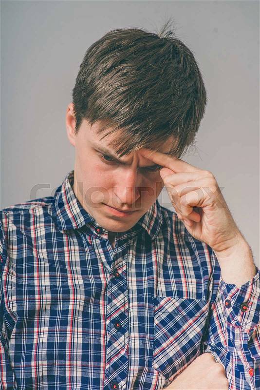 Worried man tries to remember something, stock photo
