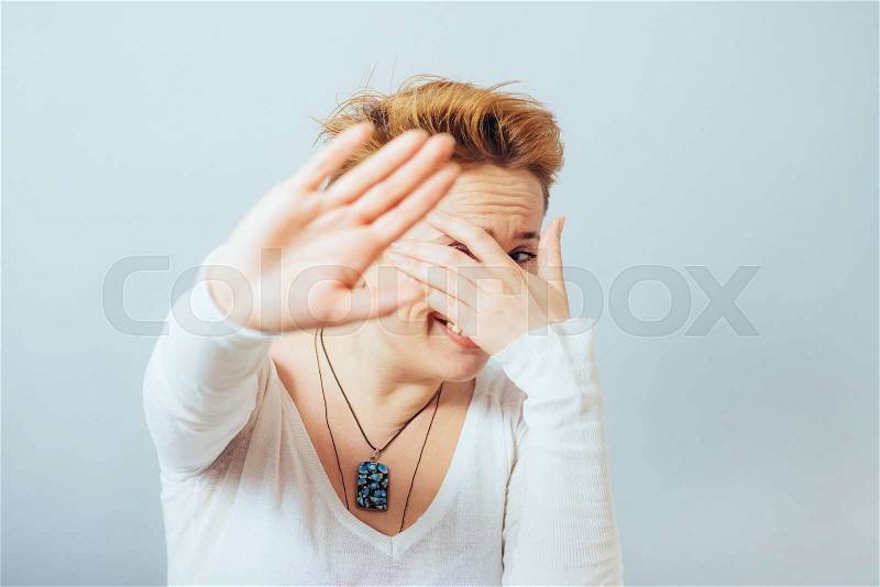 Young girl covering her eyes , stock photo