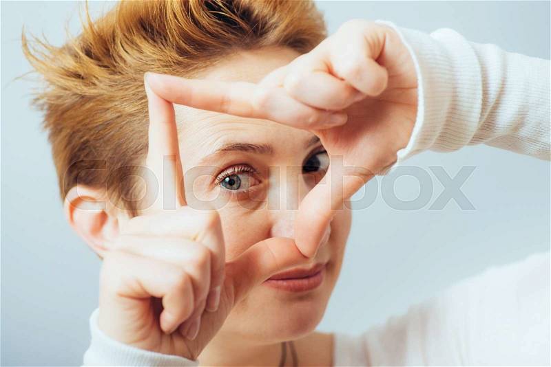 Beautiful woman making a hand frame, stock photo