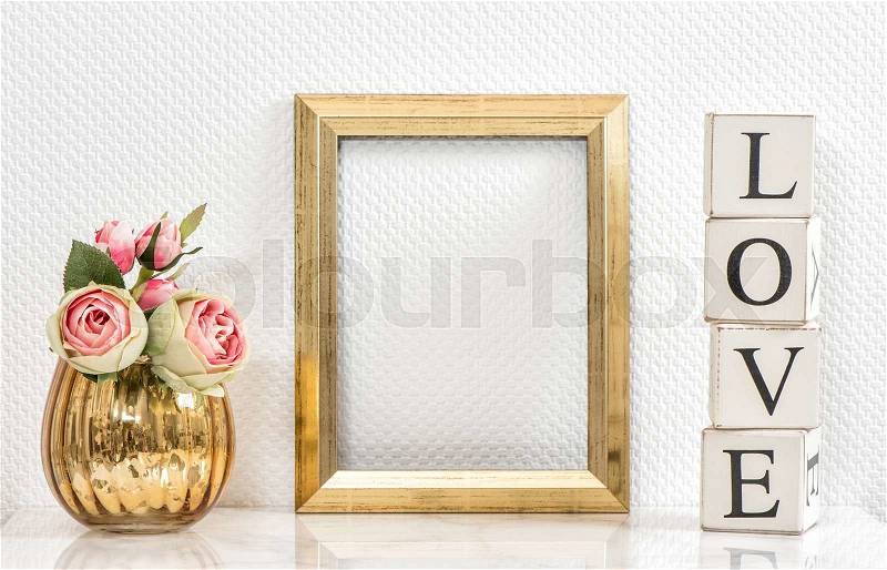 Picture frame and pink roses. Valentines Day concept. Mock up with golden frame and flowers with space for your picture or text, stock photo