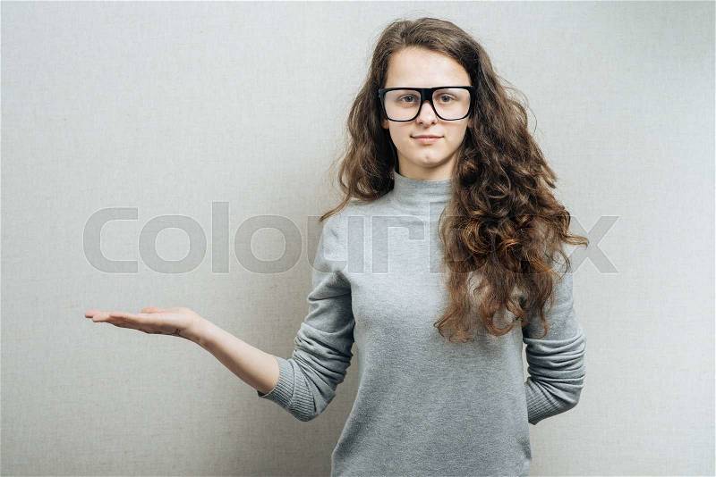 Woman showing hand. On a gray background, stock photo