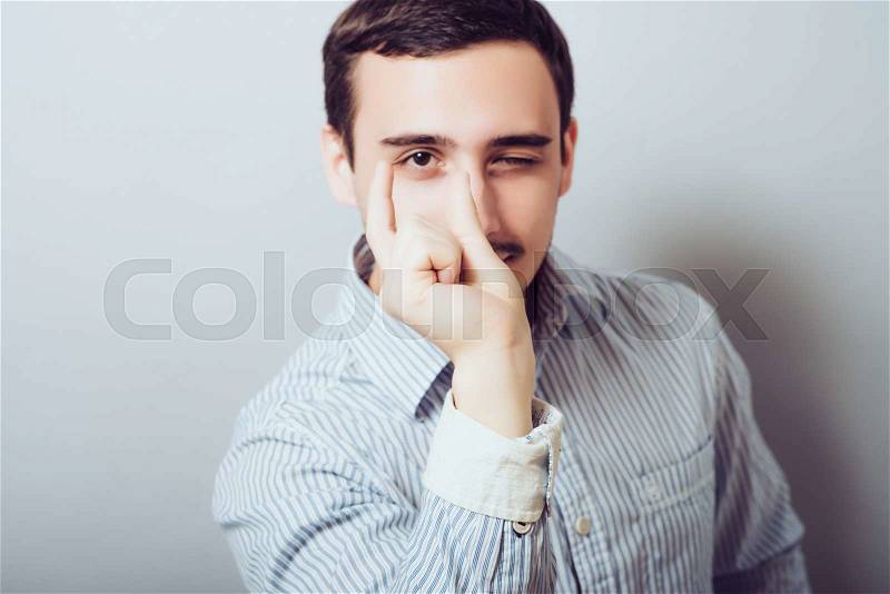 Man holding something invisible and small in the hands, stock photo