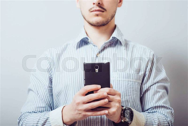 Cropped view of Businessman holding the phone, stock photo