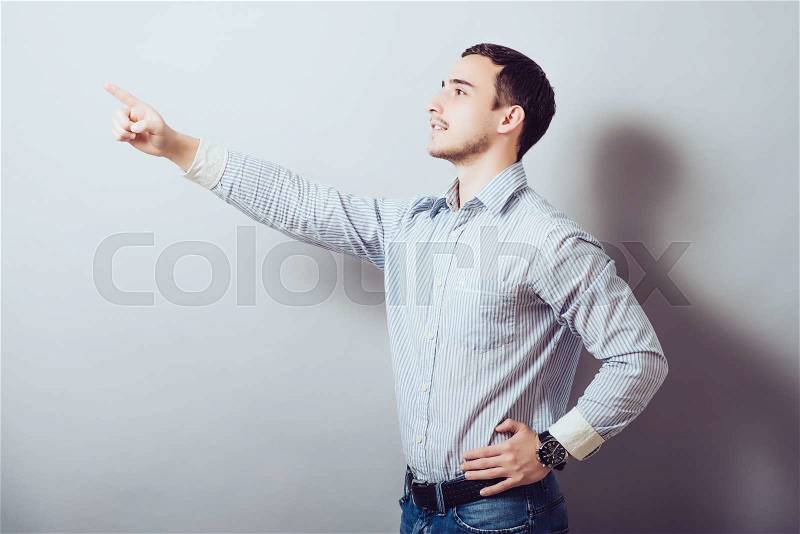 Portrait of a smart guy pointing to something, stock photo