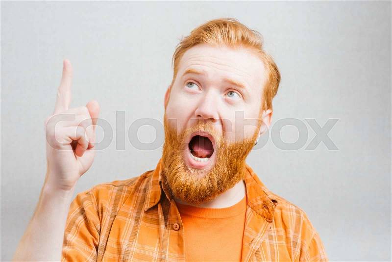 Emotional and people concept: young bearded man with good idea sign, stock photo
