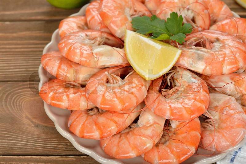 Boiled shrimp on a brown background, close-up, stock photo